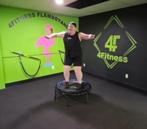 image of Tracie doing a jumping jack on a rebounder